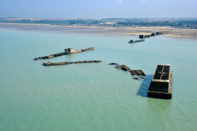 Caisson Phoenix vu depuis la côte d’Arromanches, ligne de vestiges du port artificiel allié.